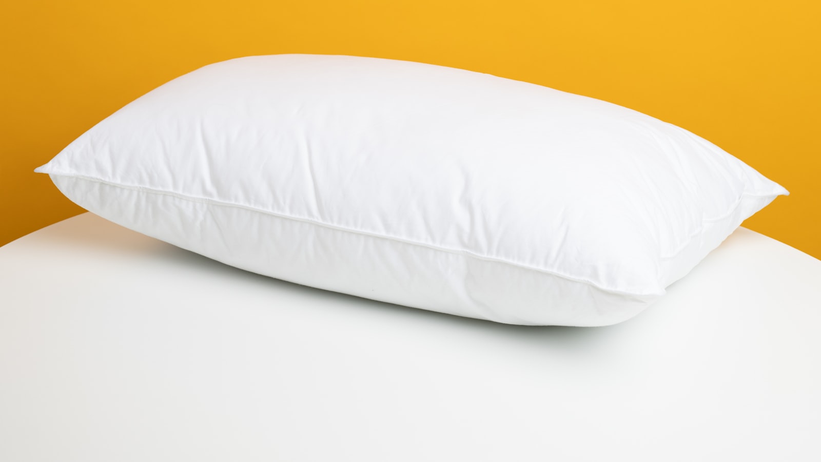 Stacked pillows on a made bed